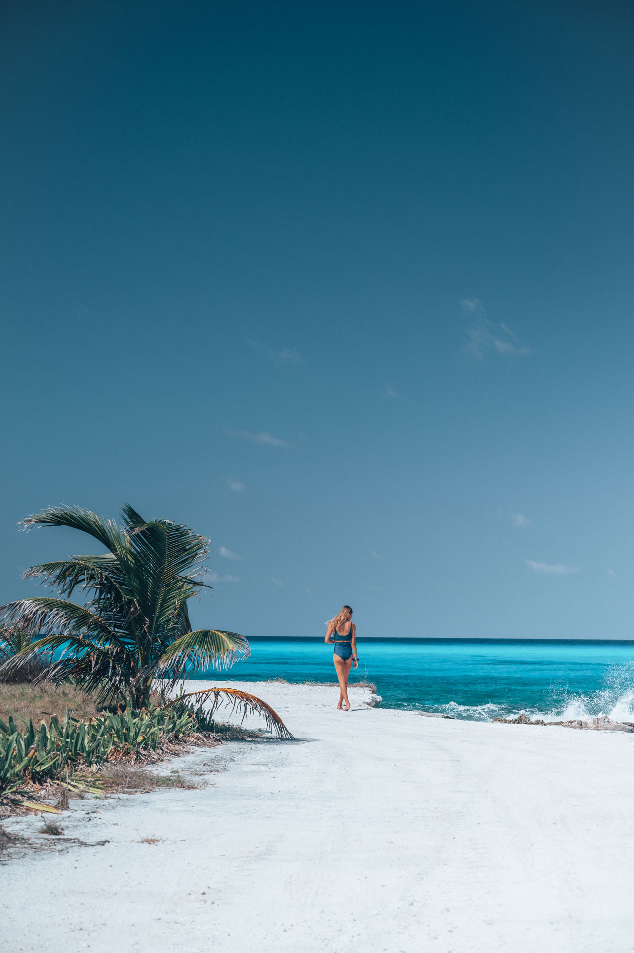 Lone figure on pristine white Exumas beach
