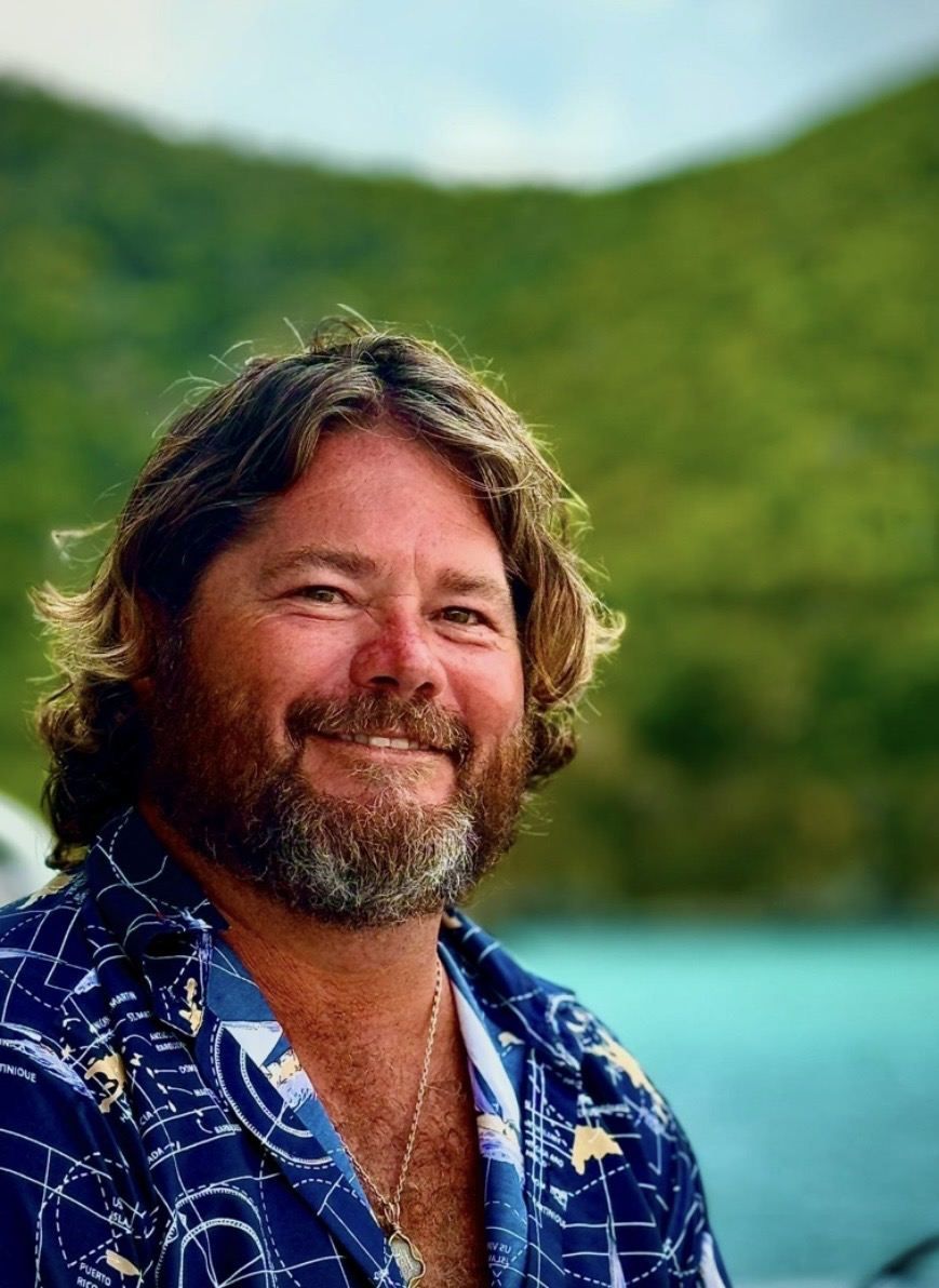 Captain Sammy Baker smiling warmly in nautical attire