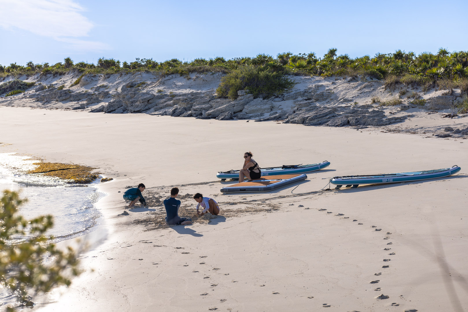 PurelyBlu's inflatable dock and paddleboards pulled up on an empty Exumas beach