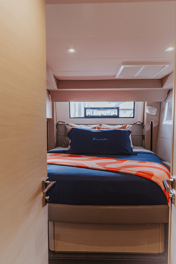 Clean cabin interior with PurelyBlu navy branded bedding