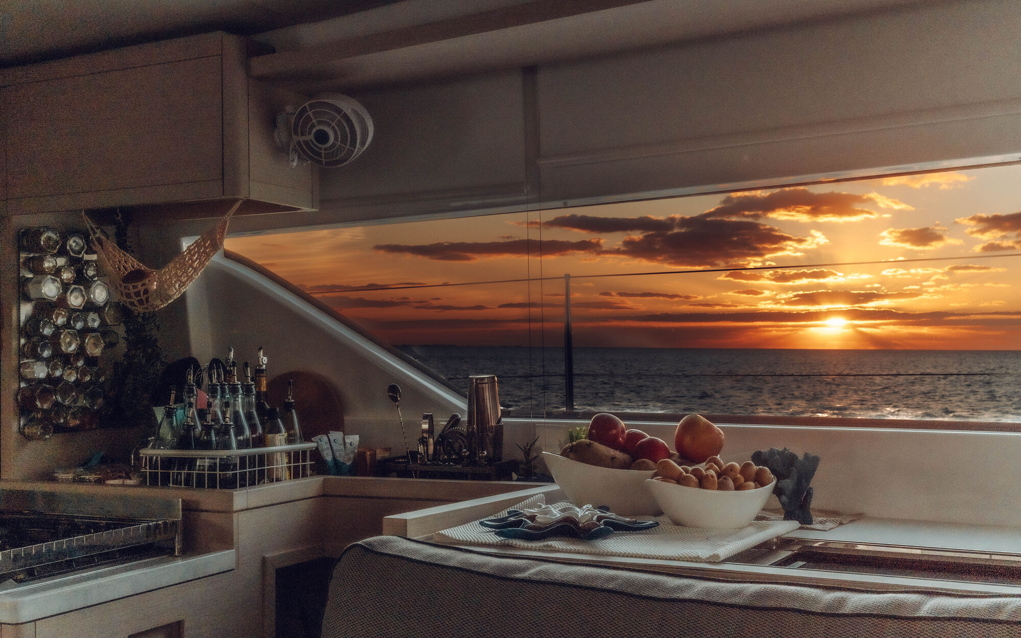 PurelyBlu galley with blazing sunset visible through window